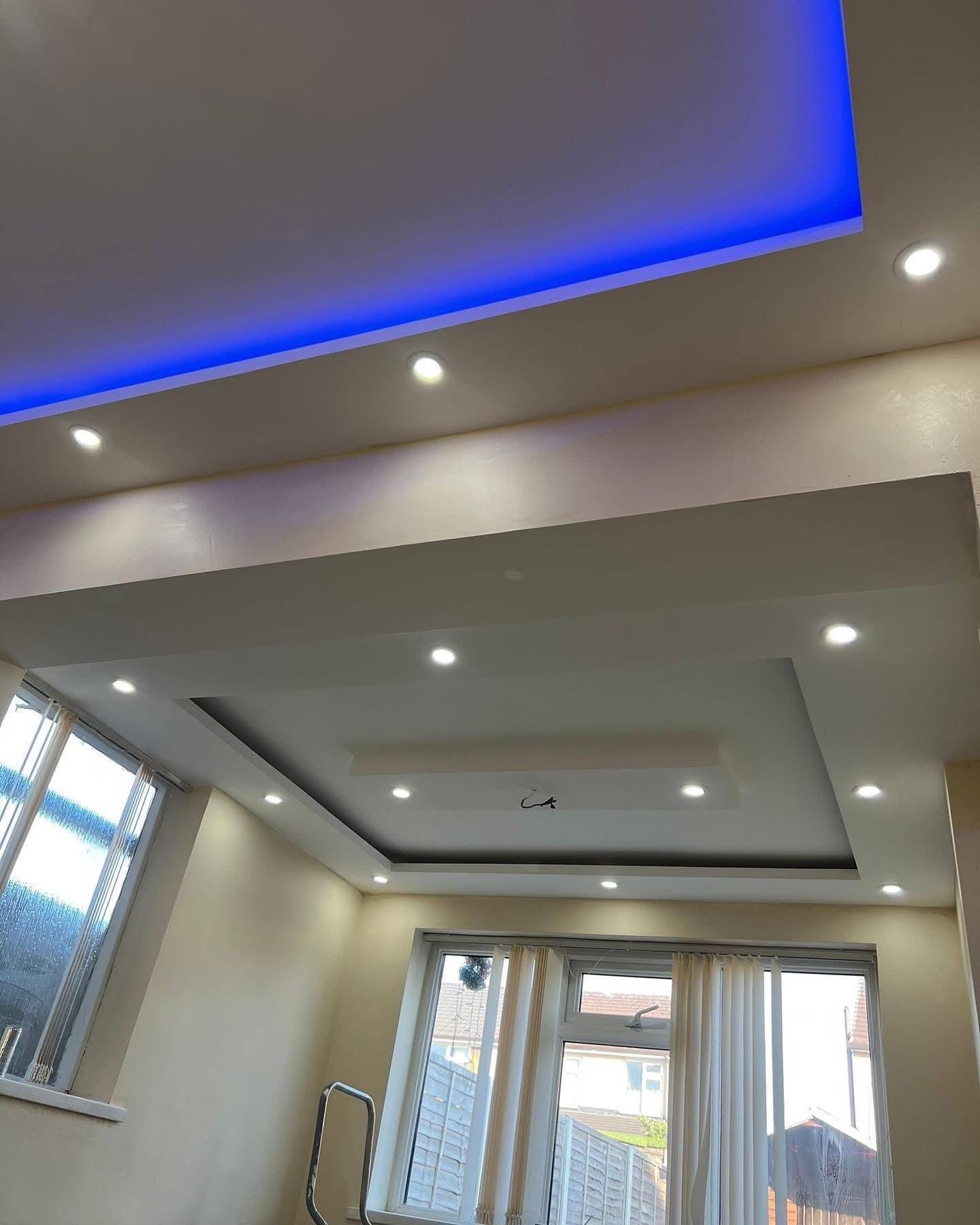 Layered plasterboard ceiling with spotlights and blue LED strip
