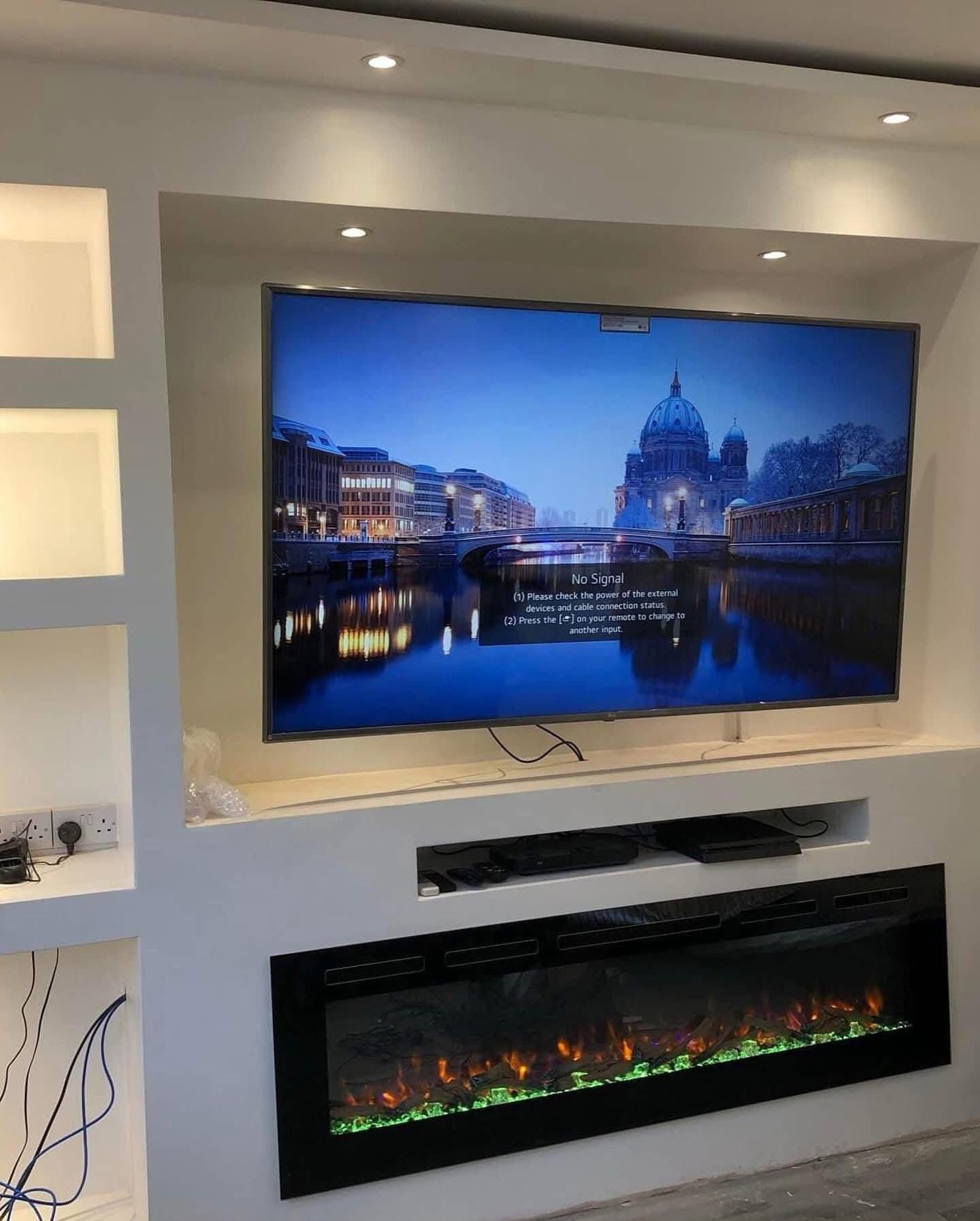 Plastered media wall with recessed TV, lit alcoves and inset electric fire